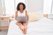 © Krakenimages.com - Middle age woman using laptop sitting on bed at bedroom