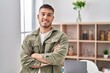 © Krakenimages.com - Young hispanic man smiling confident standing with arms crossed gesture at home