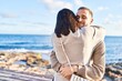 © Krakenimages.com - Man and woman couple smiling confident hugging each other standing at seaside