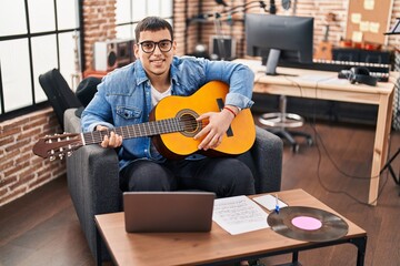 Sticker - Young man musician having online classical guitar lesson at music studio