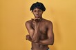 © Krakenimages.com - Young african man with dreadlocks standing shirtless looking at the camera blowing a kiss with hand on air being lovely and sexy. love expression.