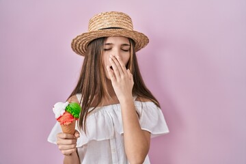 Sticker - Teenager girl holding ice cream bored yawning tired covering mouth with hand. restless and sleepiness.