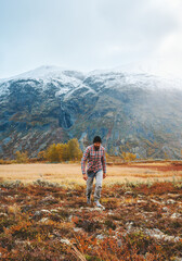 Wall Mural - Man hiking in mountains of Norway autumn season active healthy lifestyle adventure vacations trekking in Jotunheimen park eco tourism