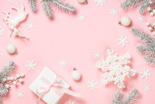 Christmas Flat Lay Background At Pink. Fir Tree, Present Box And White Christmas Decorations. Top View With Copy Space.