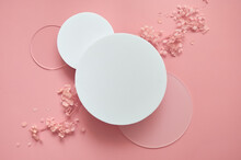 White Round Podium Pedestal Cosmetic Beauty Product Presentation Scene Empty Mockup On Trendy Pink Coral Pastel Background With Spring Flowers, Minimalist Flat Lay Backdrop Luxury Template, Top View.