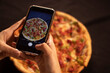 © Hiram - cell phone taking a picture of a pizza