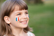 © Svetlana - Portrait of child with painted French flag, closeup. Kid fan with blue white red flag painted on face. Education abroad. 14 July, Bastille day, main France national holiday