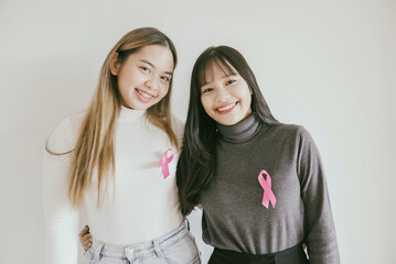 Wall Mural - Young Asian women with pink ribbons, breast cancer awareness, October pink concept, world cancer day