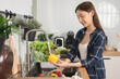 © Pormezz - Close up of hands people washing vegetables by tap water at the sink in the kitchen to clean ingredient prepare a fresh salad.