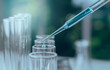 © krisana - Researcher with glass laboratory chemical test tubes with liquid for analytical , medical, pharmaceutical and scientific research concept.