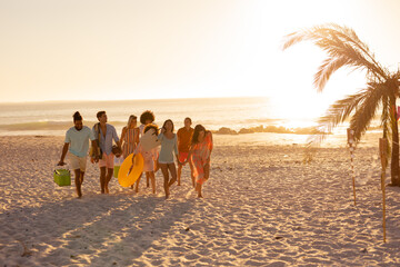 Wall Mural - Mixed race friends group walking on beach