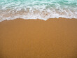 Wave on sand background at coast, beautiful texture wavy white foam blue ocean on beach coastline,sandy with sea nature. transparent water seascape island photography,vacation tropical summer.