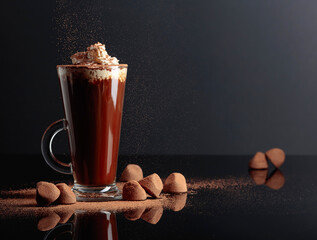 Truffles and glass of hot chocolate with whipped cream.