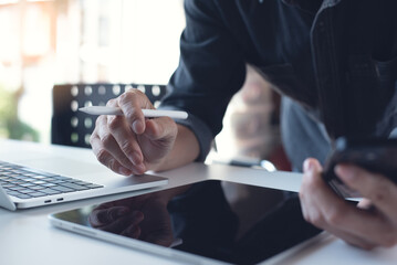 Poster - Business man working remotely on laptop computer, using digital tablet and mobile phone at home, closeup