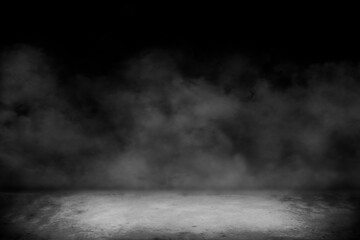 Wall Mural - Concrete floor with smoke or fog in dark room with spotlight. asphalt street, black background