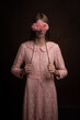 © Milou Dirks - fine art studio portrait of woman in pink dress holding flowers hiding her eyes