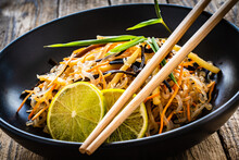 Asian Food - Konjac Noodles, Stir Fried Vegetables, Soy Sauce And Mushrooms On Wooden Table
