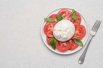 Wall Mural - Tomato salad with buratta cheese or mozzarella and basil. Traditional italian salad, mediterranean cuisine