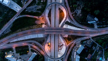 Aerial Drone Photo Of Ring Road, Multilevel Circular Junction Road, Road Junction. Aerial View Of The Transportation, Traffic, Route Road At Night In The City Of Chiangmai Thailand.