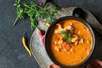 Wall Mural - bowl of thai tomato soup with shrimp on dark table