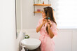 © AntonioDiaz - Beautiful woman doing her hair and getting ready in the morning