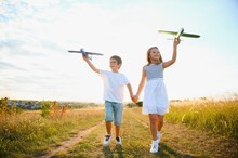 Children Play Toy Airplane. Concept Of Happy Childhood. Children Dream Of Flying And Becoming A Pilot.