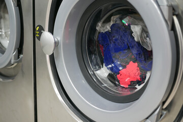 Wall Mural -  close up of cloths in a washing machine.