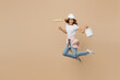 Full body young employee laborer handyman woman in white t-shirt helmet jump high hold paint roller bucket isolated on plain beige background Instruments accessories renovation room. Repair concept.