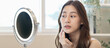 © Pormezz - Close up young beautiful asian woman looking at mirror at home