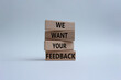 © Natallia - We want your feedback symbol. Wooden blocks with words We want your feedback. Beautiful white background. We want your feedback concept. Copy space.