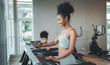 © Me studio - Healthy woman running on sports treadmill with daughter.Exercise for health and body health, to practice sports.children running on sports treadmill in gym.