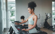 © Me studio - Healthy woman running on sports treadmill with daughter.Exercise for health and body health, to practice sports.children running on sports treadmill in gym.