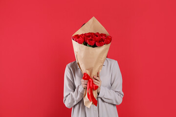 Poster - Woman with tulip bouquet on red background. 8th of March celebration