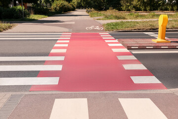 Wall Mural - Bicycle lane with painted white sign and pedestrian crossing outdoors