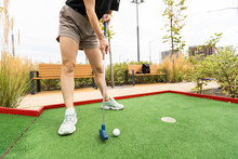 Closeup Of Player Play Mini Golf With Ball