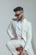 © Viorel Sima - bearded fashion businessman in suit looking down side and sitting