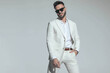 © Viorel Sima - smart casual guy in white suit with open collar shirt holding hand in pocket