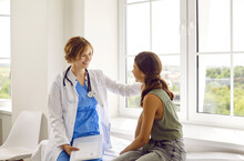 Teenage Child Visits Friendly Doctor. Cheerful, Positive Pediatrician In White Coat Smiles And Puts Her Hand On Shoulder Of Happy School Girl. Healthcare, Medical Checkup, Trust, And Support Concept