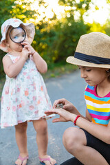 Canvas Print - The child is playing with the frog. Selective focus.