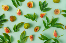 A Seamless Pattern Or Backdrop Made Of Fresh Green Leaves And Figs Against Pastel Green Background. Design For Seasonal Banner Or Advertisement