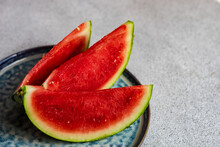 Overhead View Of Three Slices Of Watermelon On A Plate