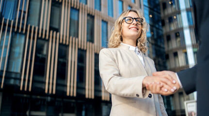 Partners a man and a woman financiers go to work at a bank, hold a tablet in their hands and communicate