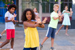 © JackF - Positive african-american girl performing street dance with her friends outdoors.