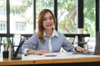 © wattana - Beautiful young businesswoman working with financial reports at her workplace..