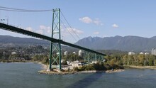 Lions Gate Bridge From Ship Vancouver Canada. The Port Of Vancouver Is The Largest Port In Canada. Bridge From Stanley Park, Cargo, Freight, Industry And Cruise Ship Marina And Facilities.
