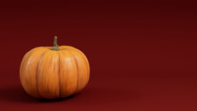 Pumpkin On A Dark Red Colored Background. Fall Themed Wallpaper With Copy-space.