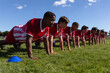 © Wavebreak Media - Rugby team doing push-ups on the playing field