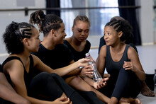 Mixed Race Modern Dancers Talking Together In A Studio