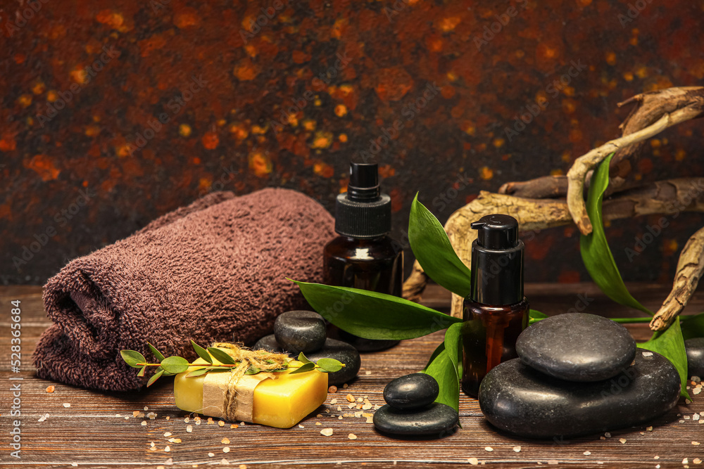 Beautiful spa composition with plant branch on wooden table