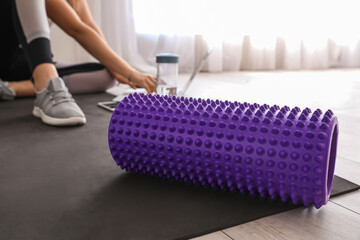Wall Mural - Foam roller on fitness mat in room, closeup